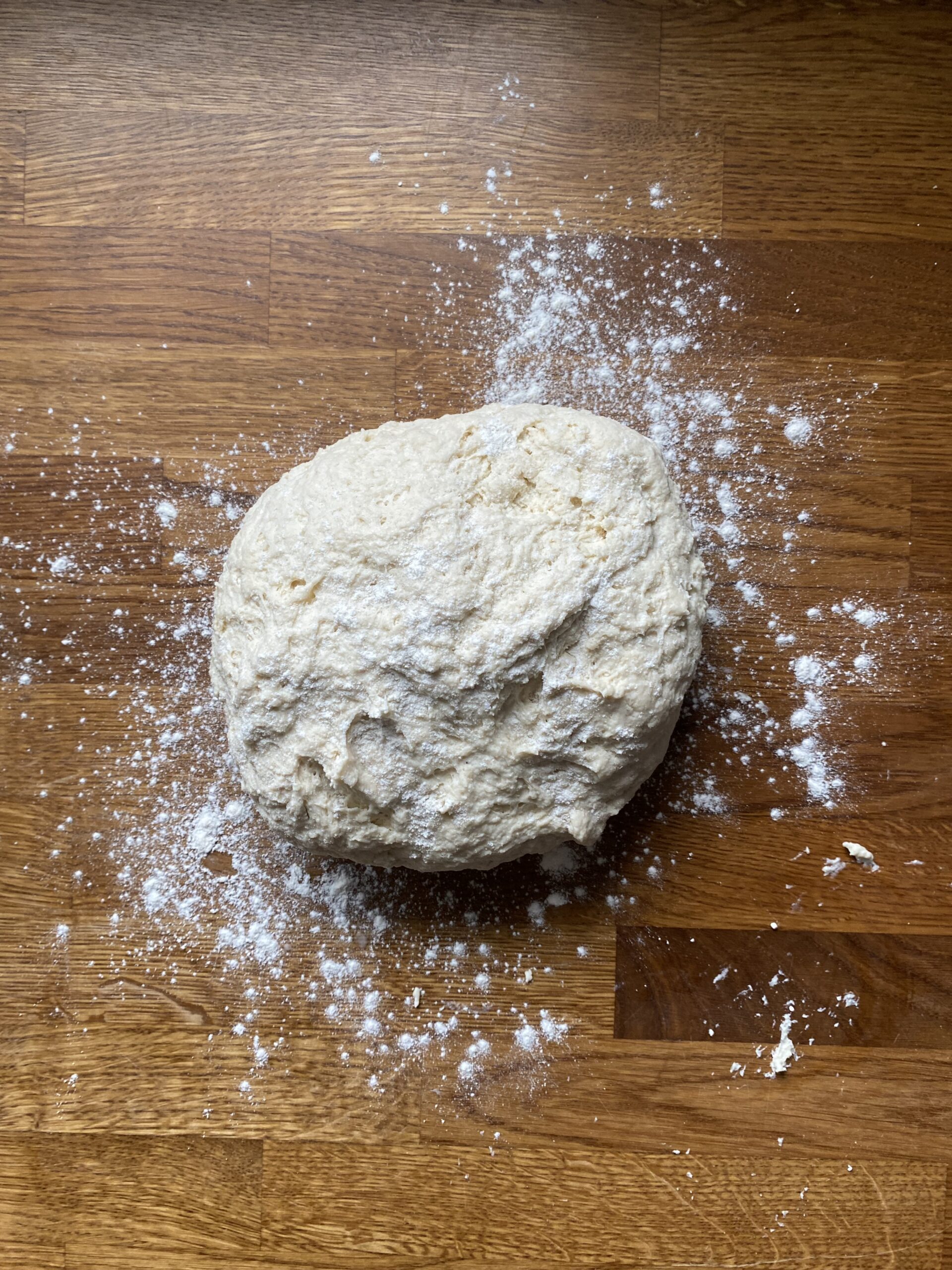 Sourdough discard flatbread dough on a lightly floured surface to knead.