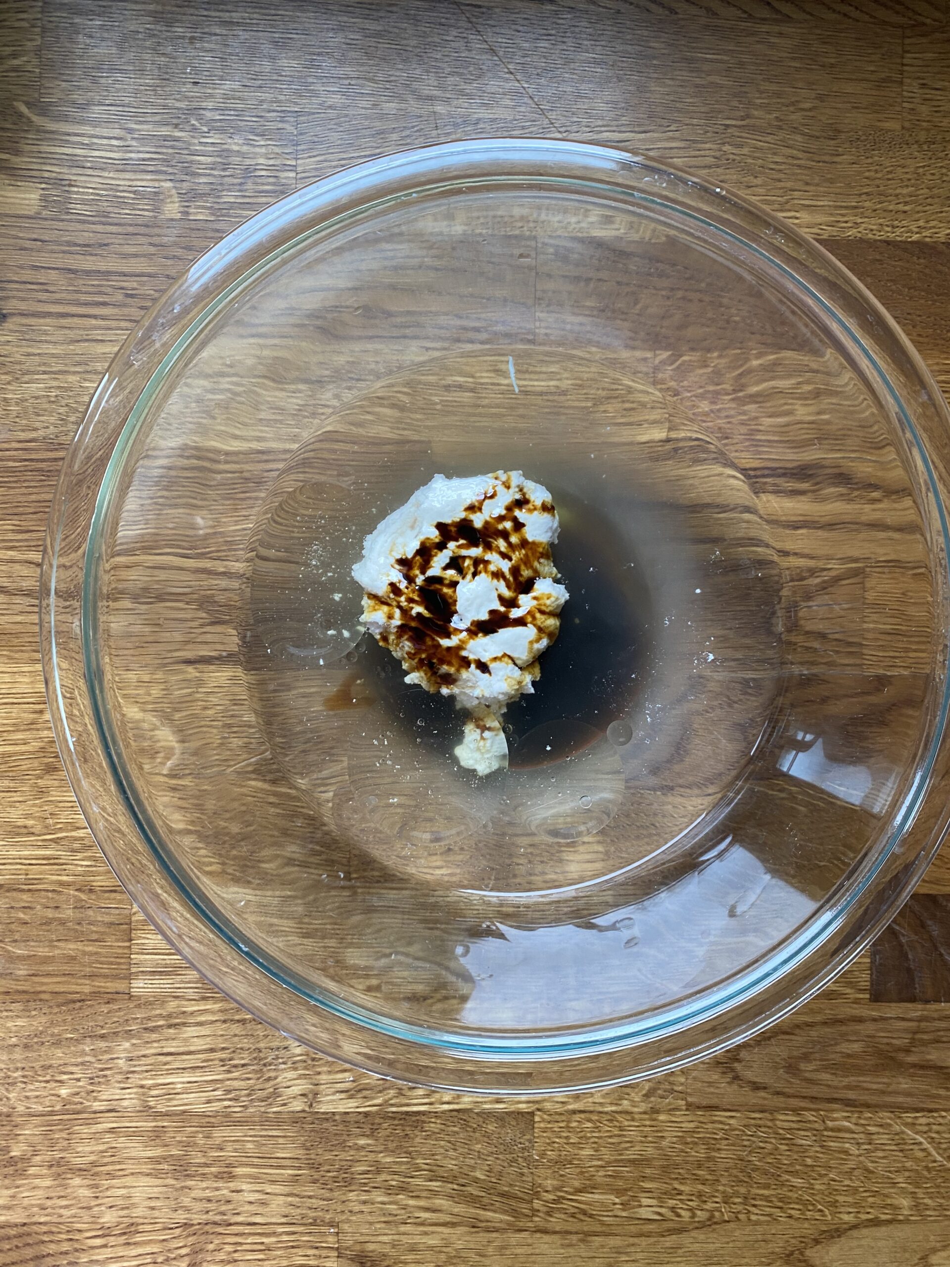 Wet ingredients in a glass mixing bowl.