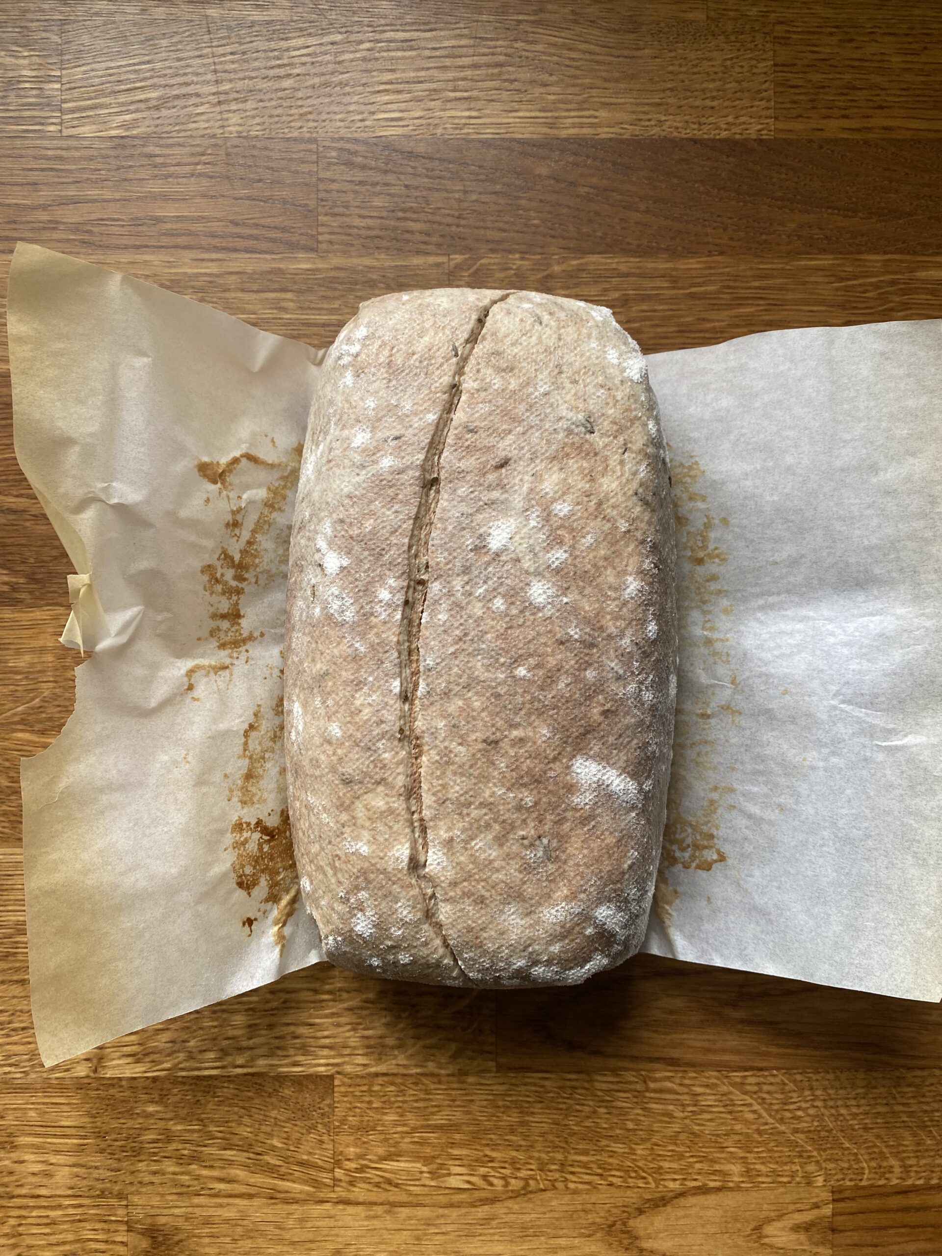 The scored loaf on a piece of parchment.