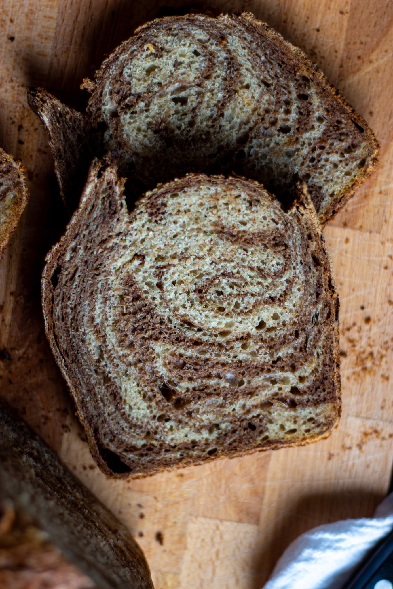 Slices of marble sourdough rye on a cutting board.