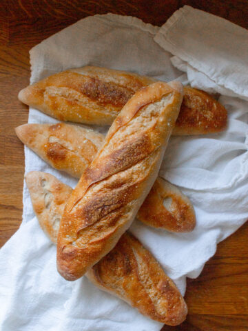 four freshly baked sourdough baguettes